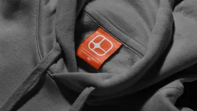 Orange AM Watt brand label on a grey hoodie – american-terawatt