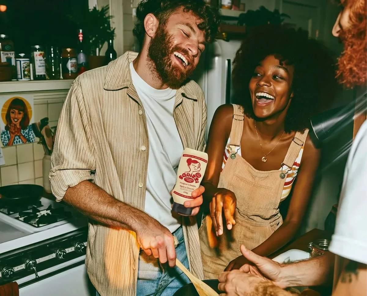 squizzi – Friends laughing in a kitchen while cooking with Squizzi sauce