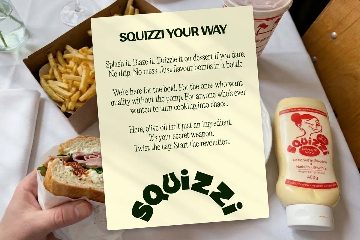 squizzi – Squizzi Your Way manifesto card on a table with a sandwich and fries